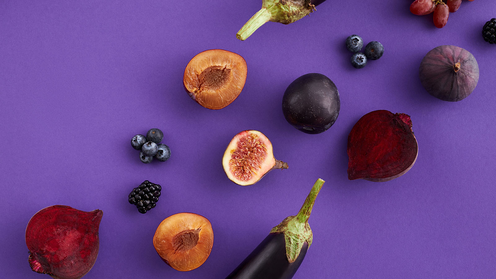 Close-Up Shot of Purple Fruits and Vegetables on a Purple Surface