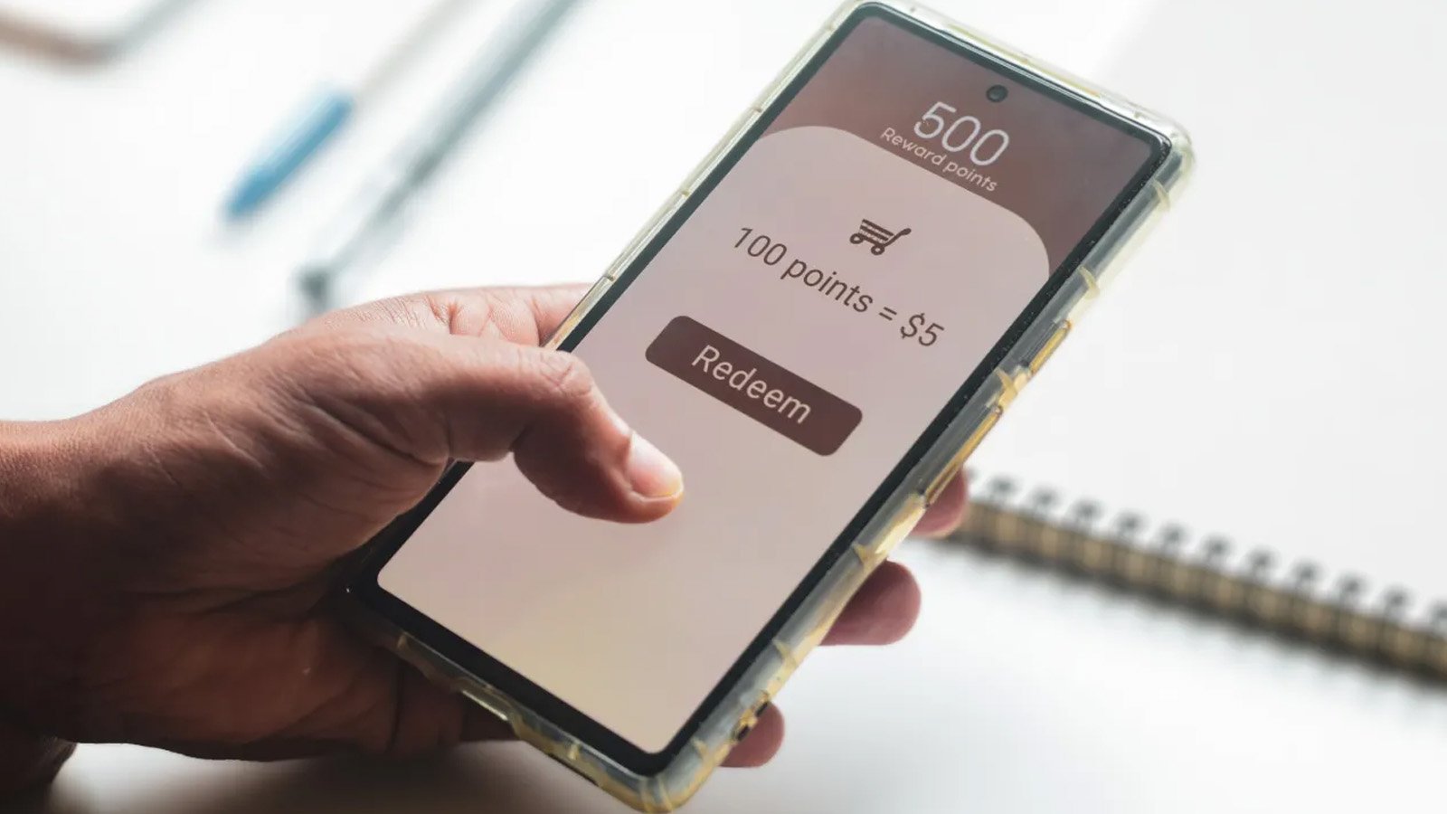 Man trying to transfer redeem rewards points into cash on his mobile phone