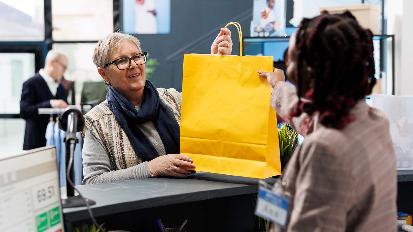 Senior shopaholic woman taking shopping bags